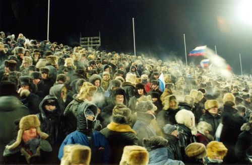 Steadfast Arkhangel'sk fans in -30 degree temperatures watch the hockey mayhem on the ice during the "Championship of Peace" tournament between Sweden and Russia. February of 1999.